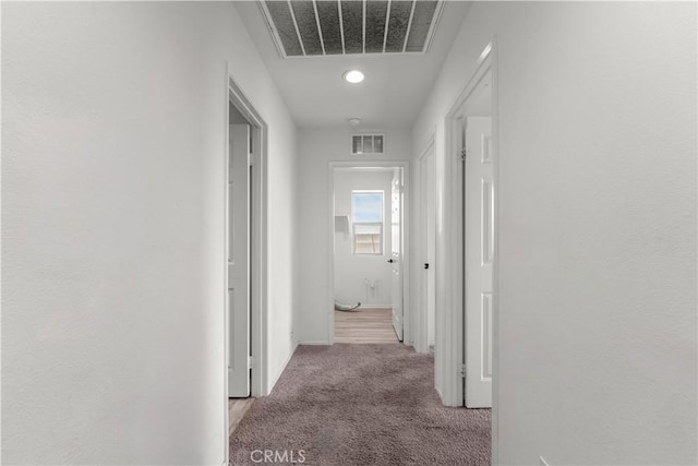 hallway featuring light carpet