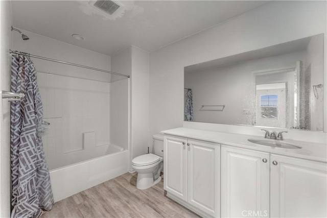 full bathroom featuring vanity, wood-type flooring, shower / bath combination with curtain, and toilet