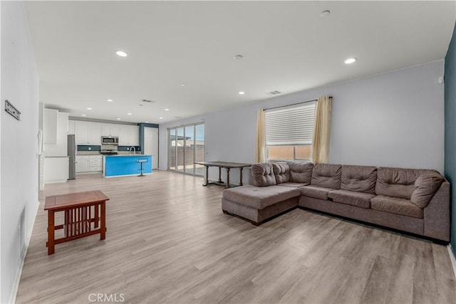 living room with light hardwood / wood-style flooring