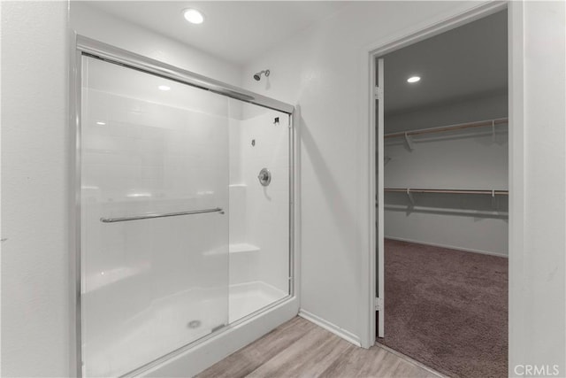 bathroom featuring walk in shower and hardwood / wood-style flooring