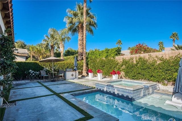 view of pool with a patio area and an in ground hot tub