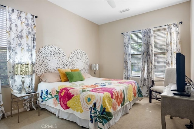 bedroom with light carpet and ceiling fan