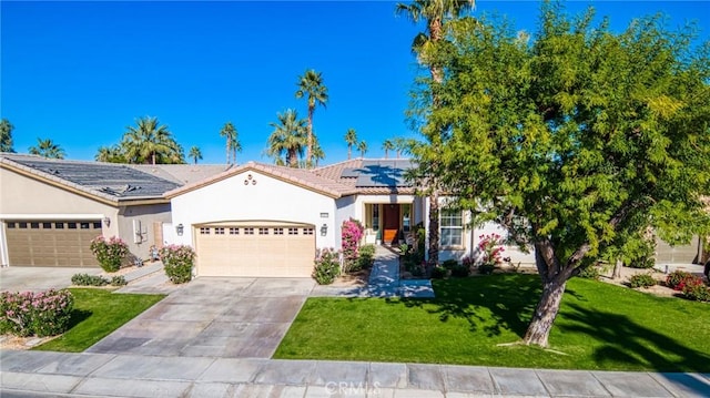 view of front of property featuring a front lawn, a garage, and solar panels