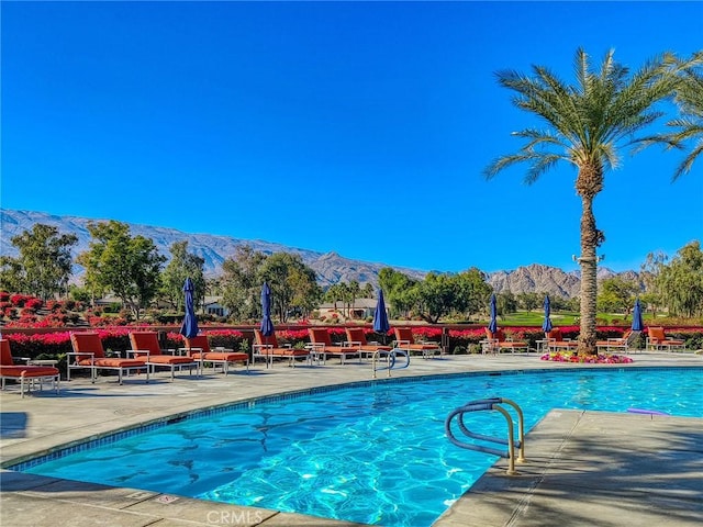 view of pool with a patio area and a mountain view