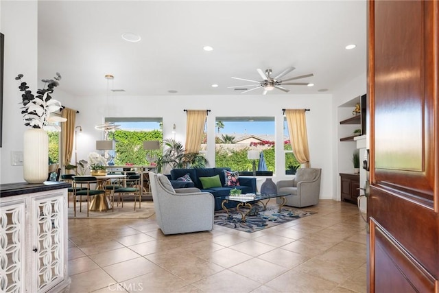 living room with ceiling fan and light tile patterned flooring