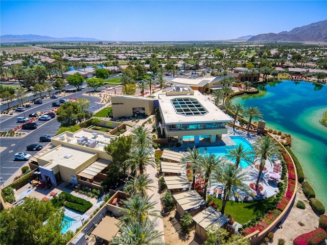 birds eye view of property with a water and mountain view