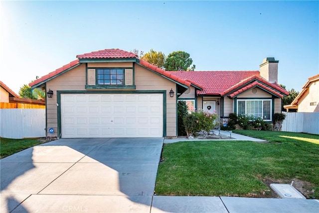 view of front of home featuring a front yard and a garage