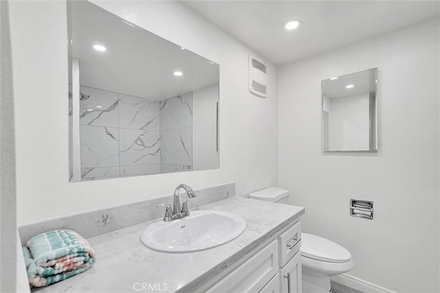 bathroom with toilet, a shower, and vanity