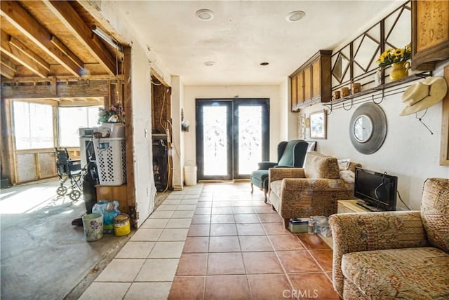 interior space with light tile patterned floors and french doors