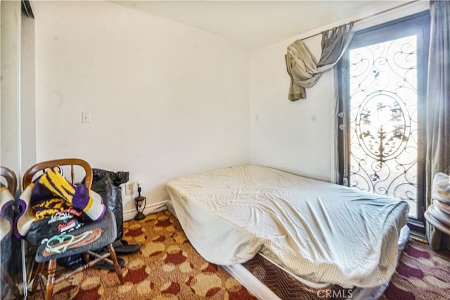 bedroom featuring vaulted ceiling and dark colored carpet