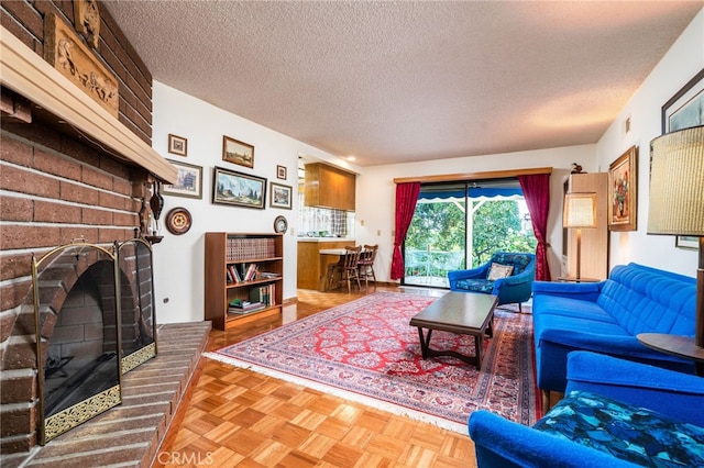 living room featuring a textured ceiling, a fireplace, and parquet flooring