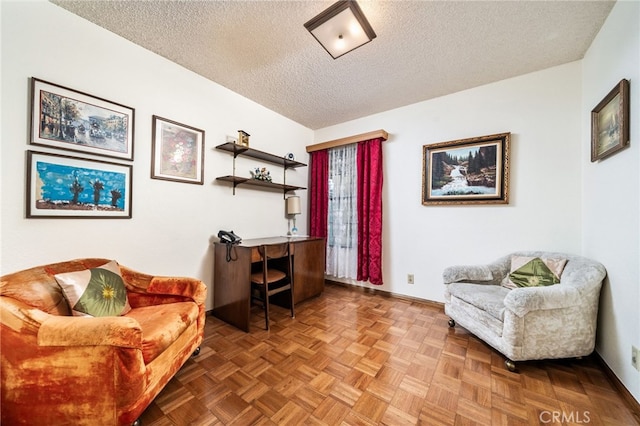 sitting room featuring parquet floors and a textured ceiling