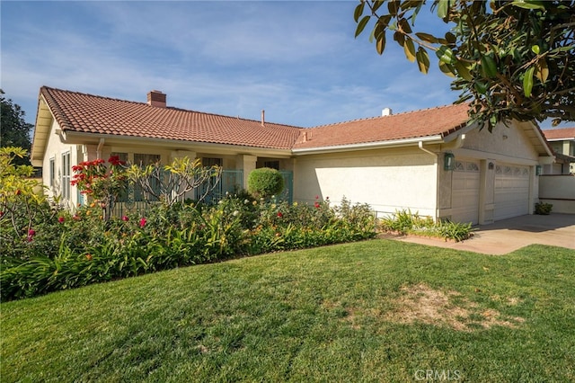 view of front of property with a front lawn and a garage