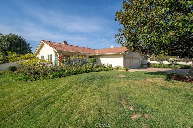 single story home with a front yard and a garage