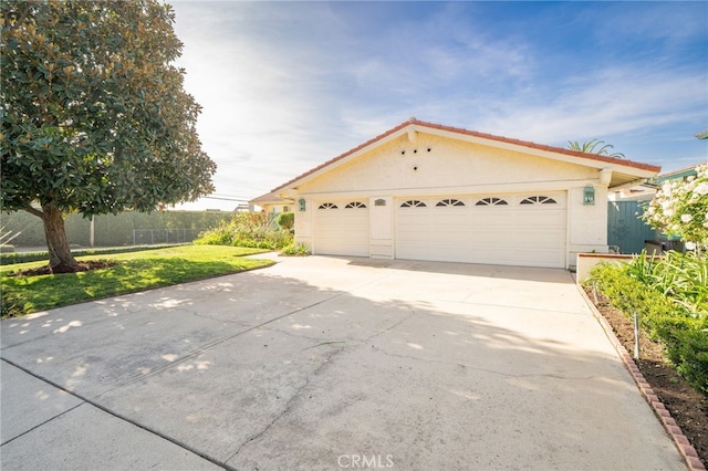 view of front of home with a front lawn and a garage