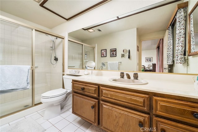 bathroom with a shower with shower door, toilet, vanity, and tile patterned flooring