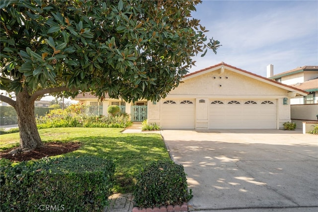 view of front of house with a front lawn and a garage