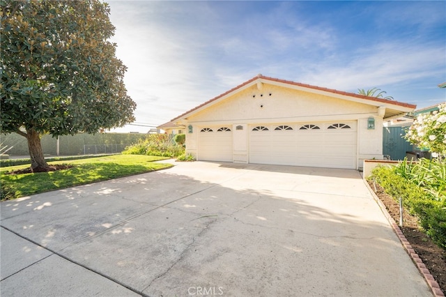 view of front facade with a front yard and a garage