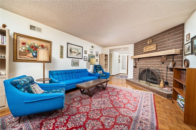 living room featuring a textured ceiling, a brick fireplace, and parquet flooring