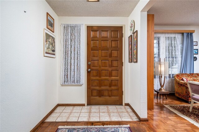 foyer entrance featuring a textured ceiling