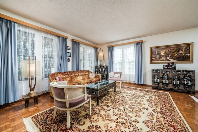 living room with parquet flooring and a textured ceiling