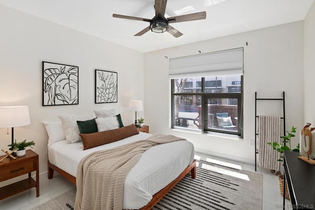 tiled bedroom with ceiling fan