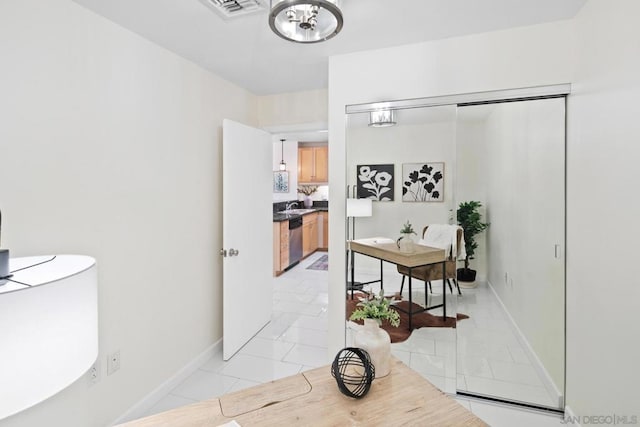 hallway with sink and light tile patterned floors