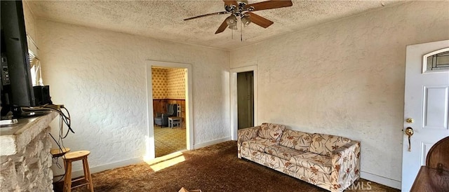 living area featuring a textured ceiling, ceiling fan, and carpet flooring