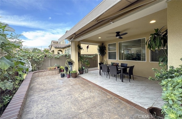 view of patio / terrace featuring outdoor dining area, ceiling fan, and fence