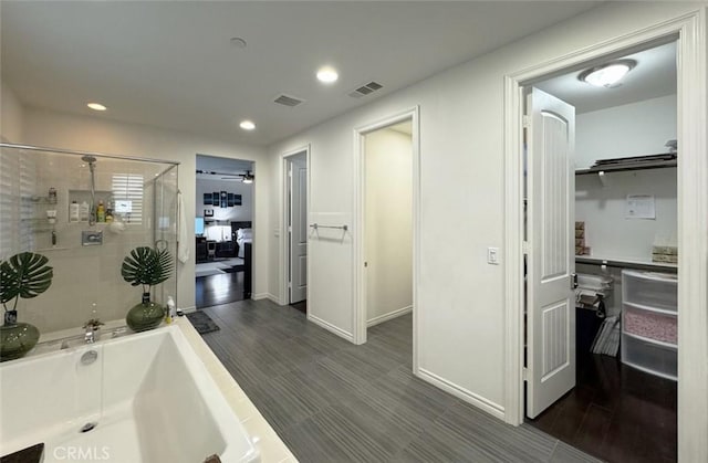 full bath with visible vents, a shower stall, wood finish floors, recessed lighting, and a bath