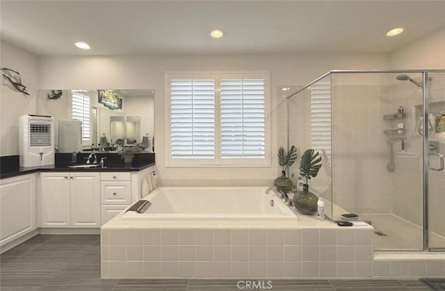 full bath with vanity, a bath, recessed lighting, and a stall shower