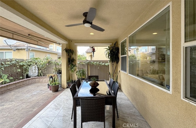 view of patio / terrace featuring outdoor dining space, a ceiling fan, and fence