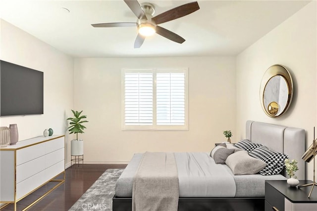 bedroom with baseboards, dark wood-style flooring, and ceiling fan