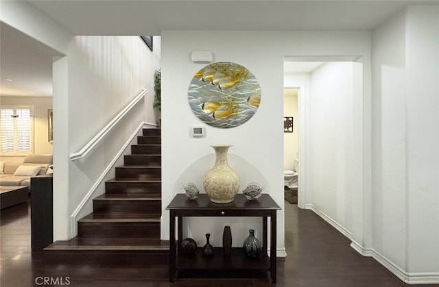 staircase with wood finished floors and baseboards