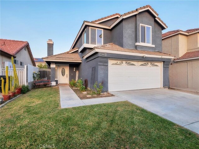 view of front of house featuring a garage and a front lawn