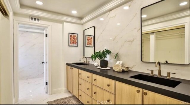 bathroom featuring vanity and ornamental molding