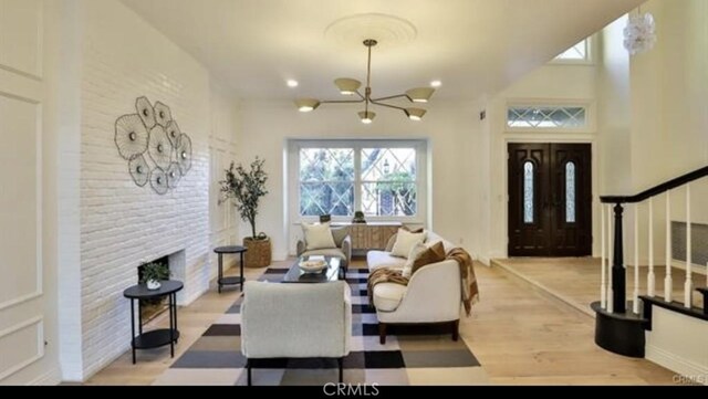 living room featuring light hardwood / wood-style flooring and a chandelier