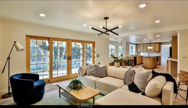 living room with french doors and an inviting chandelier