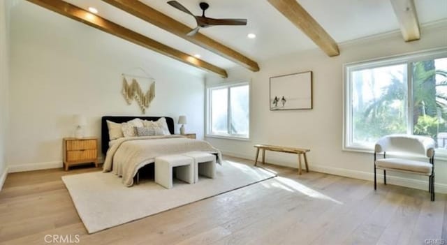 bedroom with ceiling fan, multiple windows, vaulted ceiling with beams, and light wood-type flooring