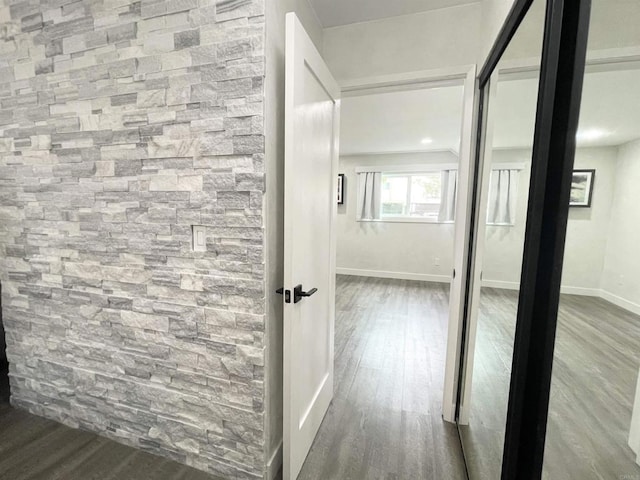 corridor with hardwood / wood-style floors