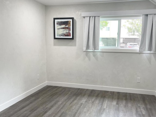 spare room featuring dark hardwood / wood-style flooring