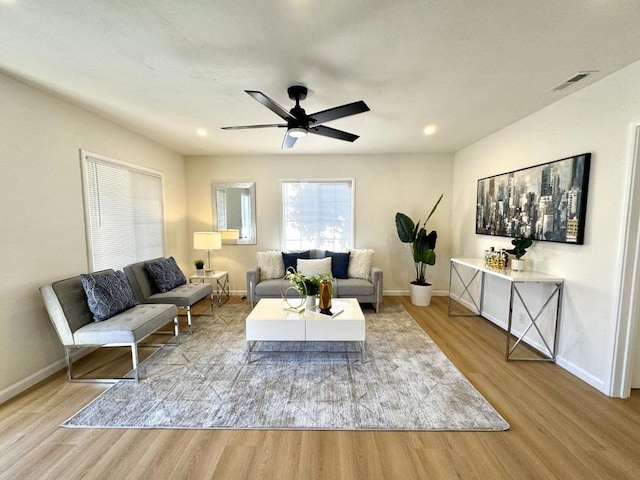 living room with wood-type flooring and ceiling fan