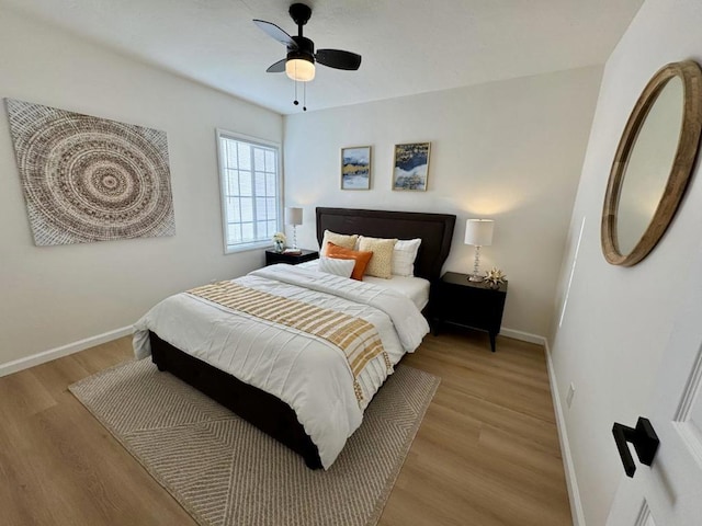 bedroom with light hardwood / wood-style floors and ceiling fan