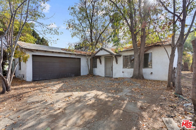 ranch-style home featuring a garage