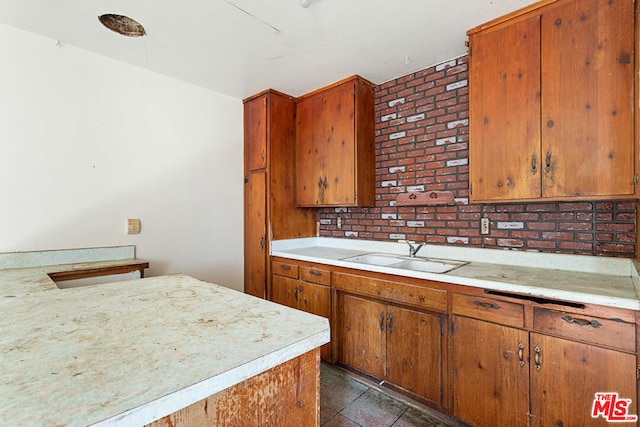 kitchen with brick wall and sink