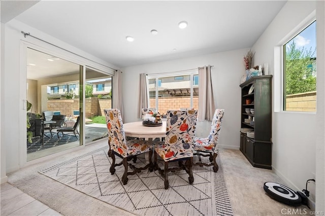 carpeted dining area with a healthy amount of sunlight