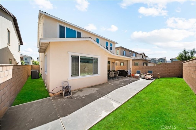 rear view of house with cooling unit, a lawn, and a patio