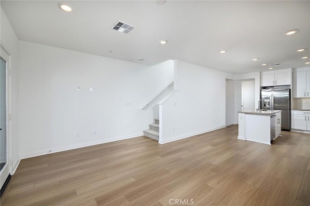 unfurnished living room featuring light wood-type flooring