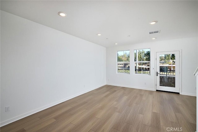 spare room with light hardwood / wood-style flooring