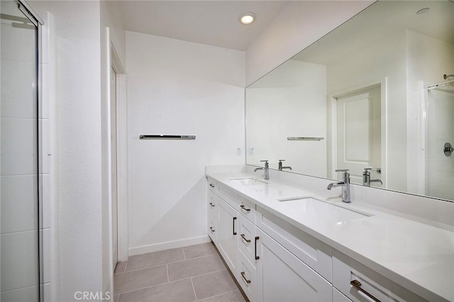 bathroom with vanity, a shower with door, and tile patterned flooring